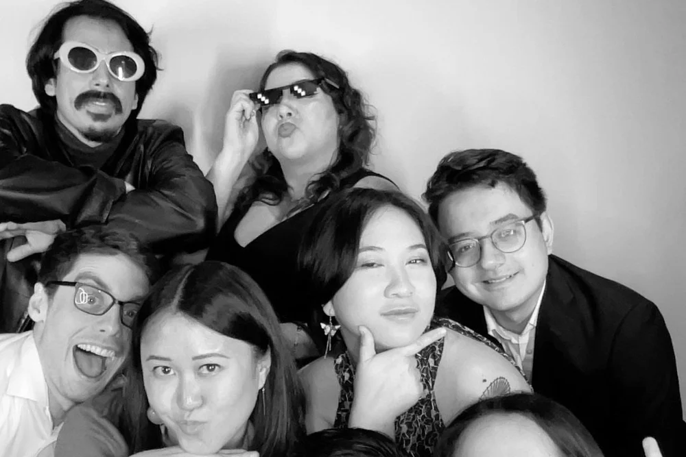 Guests posing in the OllyPix photo booth at a Deep Ellum event